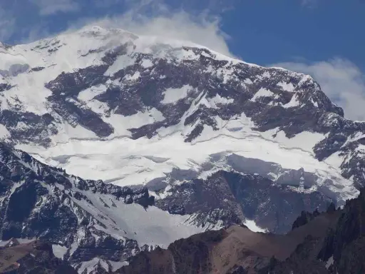 Aconcagua, najwyższy szczyt Andów, pokryty śniegiem i lodem, majestatycznie wznosi się ku błękitnemu niebu.
