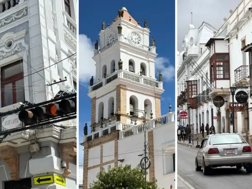 Architektura Sucre: wieża zegarowa, białe budynki z balkonami i uliczka z samochodem.